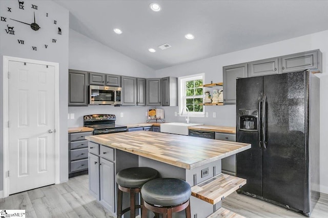 251 Heatherbrook Dr, Lyman, SC 29365 - kitchen with black appliances, butcher block countertops, gray cabinetry, a sink, and lofted ceiling