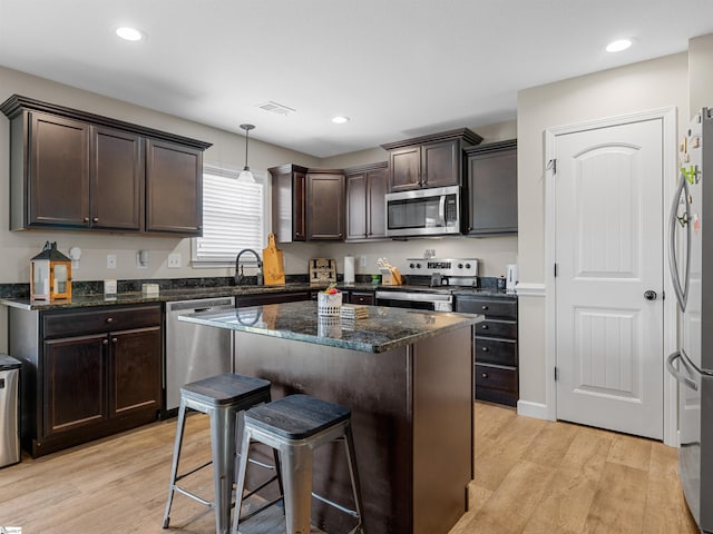 825 Brennan Way, Lyman, SC 29365 - kitchen featuring stainless steel appliances, dark brown cabinets, a kitchen bar, light wood-style floors, and recessed lighting