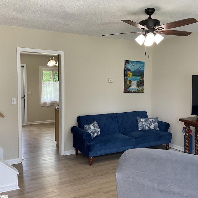 407 Old Farm Rd, Moore, SC 29539 - living area with wood finished floors, a ceiling fan, baseboards, and a textured ceiling