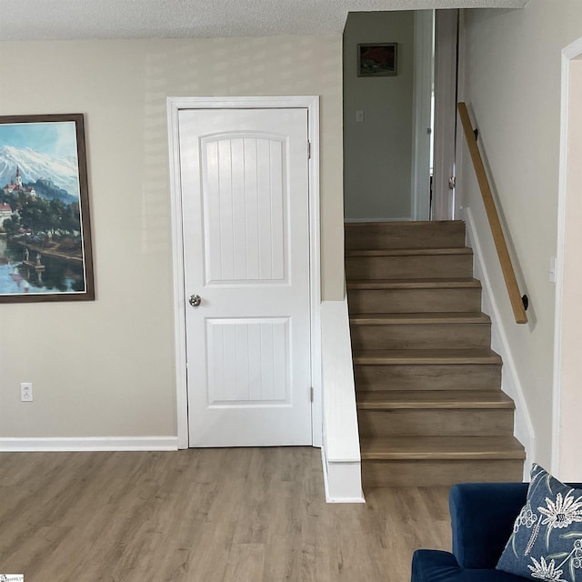 407 Old Farm Rd, Moore, SC 29539 - staircase featuring wood finished floors, a textured ceiling, and baseboards