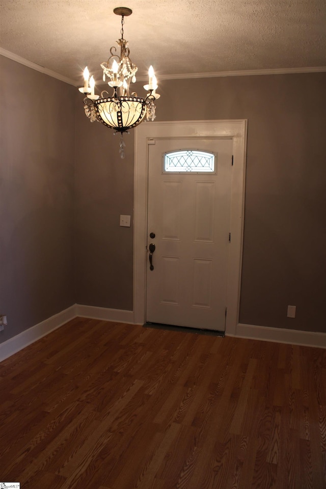 295 Dorn St, Westminster, SC 29693 - foyer entrance featuring a chandelier, dark wood-style floors, a textured ceiling, crown molding, and baseboards