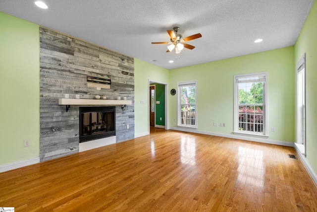 1847 Bertha Knight Rd, Lancaster, SC 29720 - unfurnished living room with ceiling fan, a stone fireplace, wood finished floors, baseboards, and recessed lighting