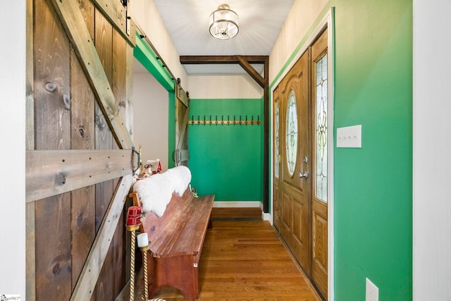 1847 Bertha Knight Rd, Lancaster, SC 29720 - entryway featuring a barn door, wood finished floors, and baseboards