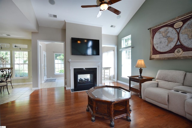 10 Bamburgh Brae Ct, Simpsonville, SC 29681 - living area featuring a ceiling fan, plenty of natural light, a multi sided fireplace, wood finished floors, and high vaulted ceiling