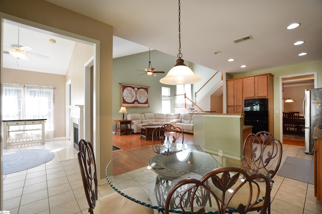 10 Bamburgh Brae Ct, Simpsonville, SC 29681 - dining space featuring ceiling fan, healthy amount of natural light, vaulted ceiling, a fireplace, and stairs