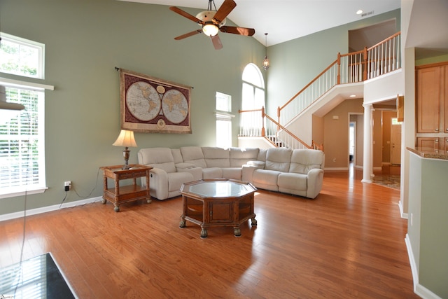 10 Bamburgh Brae Ct, Simpsonville, SC 29681 - living area with high vaulted ceiling, ceiling fan, decorative columns, and wood finished floors
