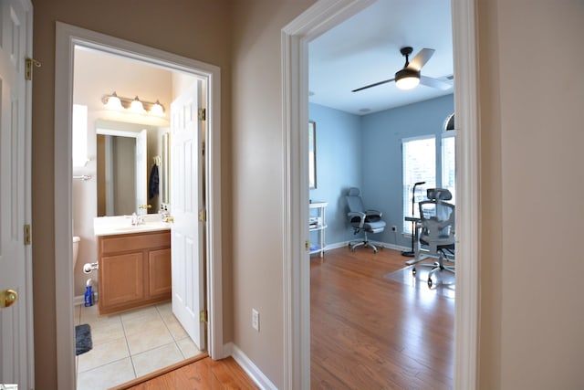 10 Bamburgh Brae Ct, Simpsonville, SC 29681 - corridor with light wood-type flooring, baseboards, and a sink