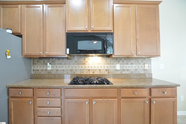 10 Bamburgh Brae Ct, Simpsonville, SC 29681 - kitchen with black appliances, backsplash, light stone countertops, light brown cabinets, and baseboards