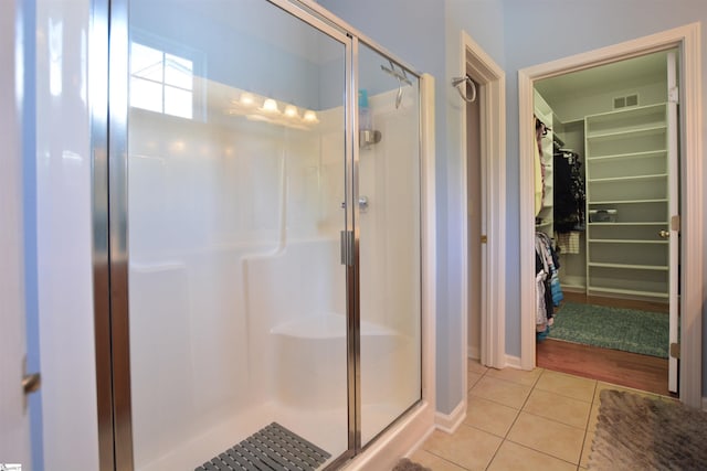 10 Bamburgh Brae Ct, Simpsonville, SC 29681 - full bathroom featuring tile patterned floors, a shower stall, a walk in closet, and baseboards