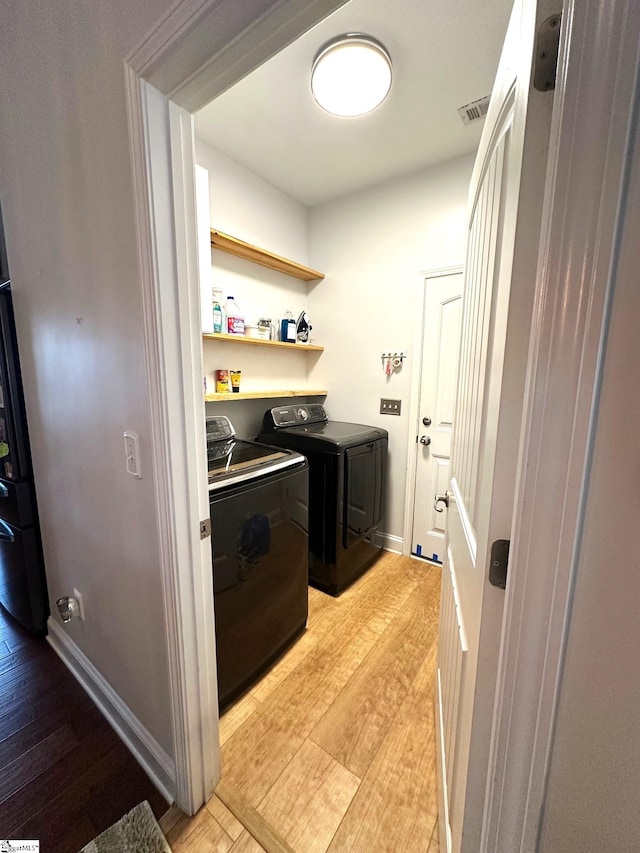 220 Scottish Ave, Simpsonville, SC 29680 - laundry room with washing machine and clothes dryer and light wood-style flooring