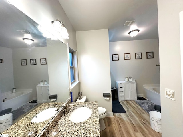 220 Scottish Ave, Simpsonville, SC 29680 - full bathroom with a bath, vanity, wood finished floors, toilet, and baseboards