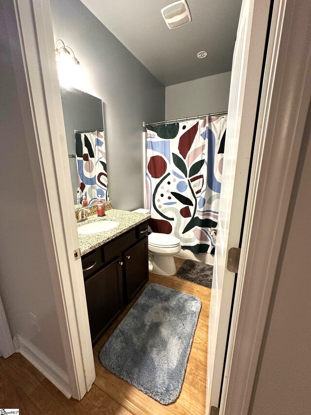 220 Scottish Ave, Simpsonville, SC 29680 - full bathroom with vanity, toilet, curtained shower, and wood finished floors