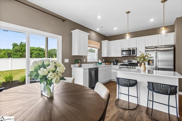 120 Randwick Ln, Greer, SC 29651 - kitchen with appliances with stainless steel finishes, a sink, white cabinetry, dark wood-type flooring, and a center island