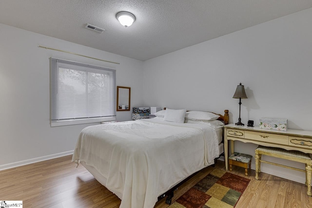 710 Amy Gray St, Greer, SC 29651 - bedroom featuring wood finished floors, a textured ceiling, and baseboards