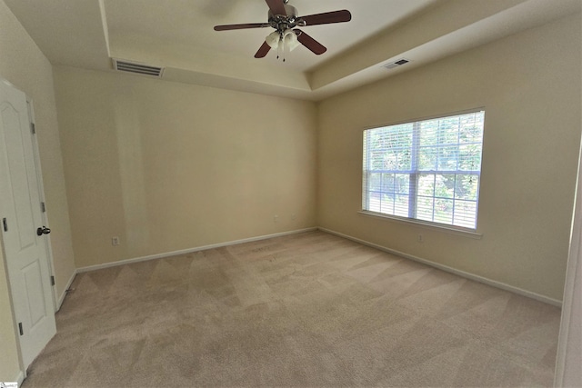 605 Spirit Mountain Ln, Easley, SC 29642 - spare room with light colored carpet, baseboards, a ceiling fan, and a tray ceiling