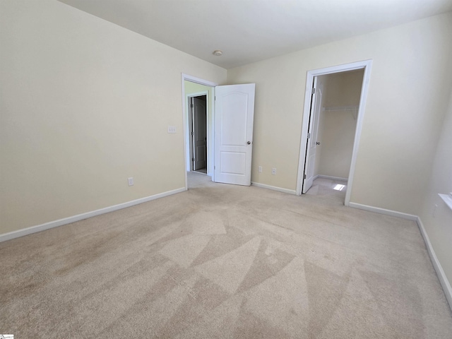 605 Spirit Mountain Ln, Easley, SC 29642 - unfurnished bedroom with light colored carpet, baseboards, a walk in closet, and a closet