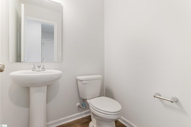 474 Grantham Ct, Spartanburg, SC 29303 - half bathroom with baseboards, wood finished floors, toilet, and a sink