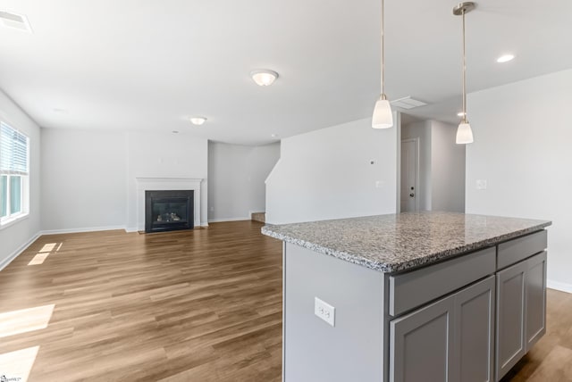 474 Grantham Ct, Spartanburg, SC 29303 - kitchen with gray cabinets, light wood-type flooring, baseboards, a center island, and pendant lighting