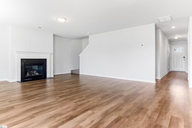 474 Grantham Ct, Spartanburg, SC 29303 - unfurnished living room featuring wood finished floors, baseboards, a glass covered fireplace, and recessed lighting