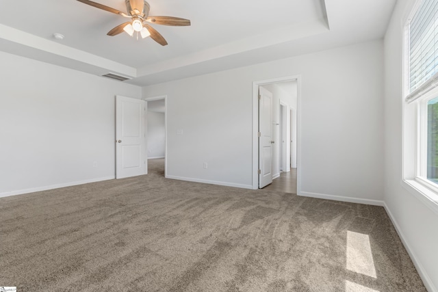 474 Grantham Ct, Spartanburg, SC 29303 - unfurnished bedroom featuring carpet, multiple windows, and a raised ceiling
