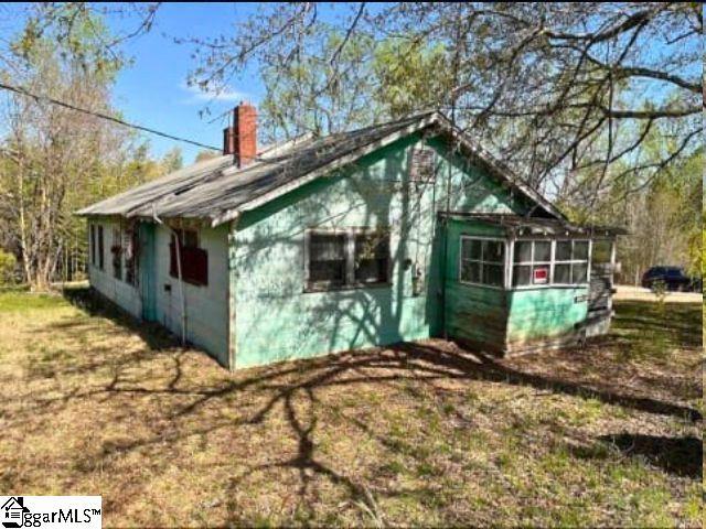 130 Poplar St, Pacolet, SC 29372 - view of property exterior with a chimney