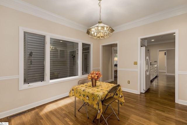 1004 Neely Farm Dr, Simpsonville, SC 29680 - dining space featuring a chandelier, ornamental molding, dark wood-style flooring, and baseboards