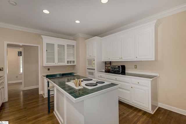 1004 Neely Farm Dr, Simpsonville, SC 29680 - kitchen featuring white appliances, tile countertops, white cabinets, baseboards, and ornamental molding