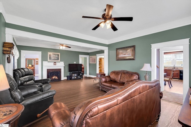 2100 Marchbanks Ave, Anderson, SC 29621 - living room featuring a ceiling fan, a brick fireplace, wood finished floors, crown molding, and baseboards