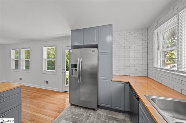 304 Robin Hood Rd, Greenville, SC 29607 - kitchen featuring butcher block counters, stainless steel appliances, gray cabinetry, plenty of natural light, and ornamental molding