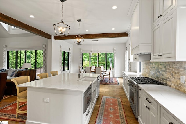 7873 Glassy Ridge Rd, Landrum, SC 29356 - kitchen with stainless steel appliances, plenty of natural light, dark wood-style floors, a kitchen bar, and recessed lighting