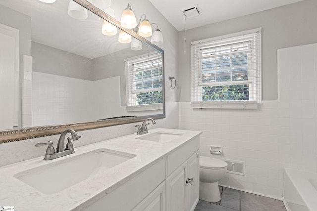 106 Chesterfield Rd, Greenville, SC 29605 - bathroom with tile walls, toilet, tile patterned floors, a bath, and double vanity