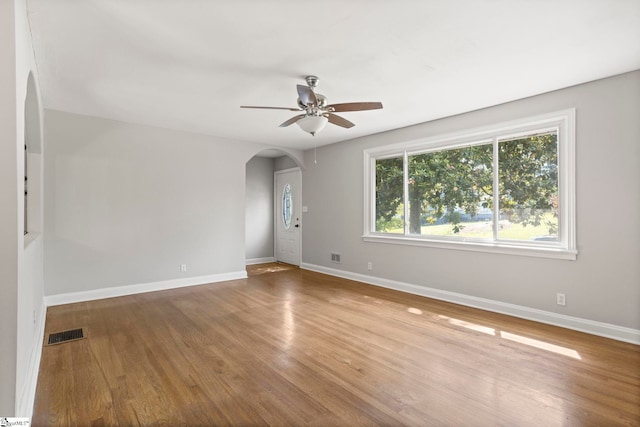 106 Chesterfield Rd, Greenville, SC 29605 - unfurnished room with arched walkways, a ceiling fan, wood finished floors, and baseboards