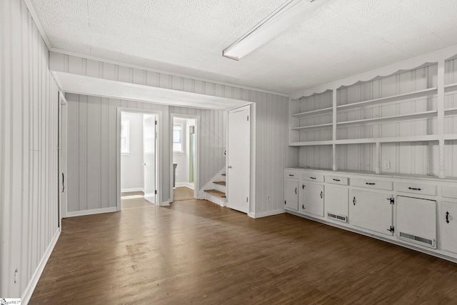 106 Chesterfield Rd, Greenville, SC 29605 - empty room with dark wood-style floors, stairs, a textured ceiling, ornamental molding, and baseboards