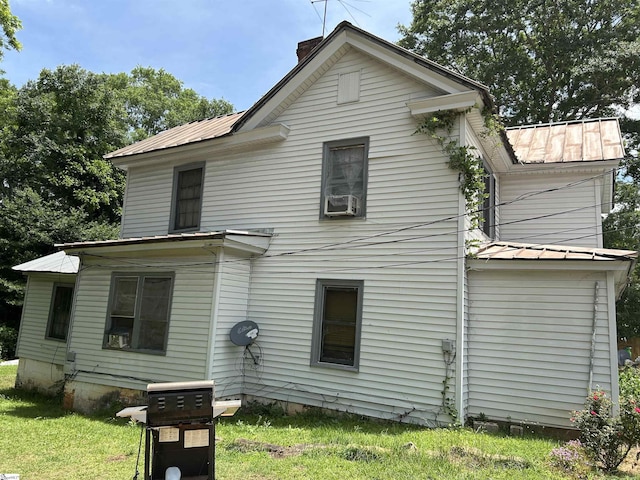304 Jones St, Laurens, SC 29360 - rear view of house with metal roof, a chimney, a yard, and cooling unit