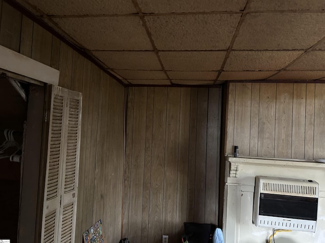 304 Jones St, Laurens, SC 29360 - detailed view of heating unit, wood walls, and a drop ceiling