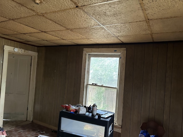 304 Jones St, Laurens, SC 29360 - dining area with wooden walls, baseboards, brick patterned floors, and a paneled ceiling