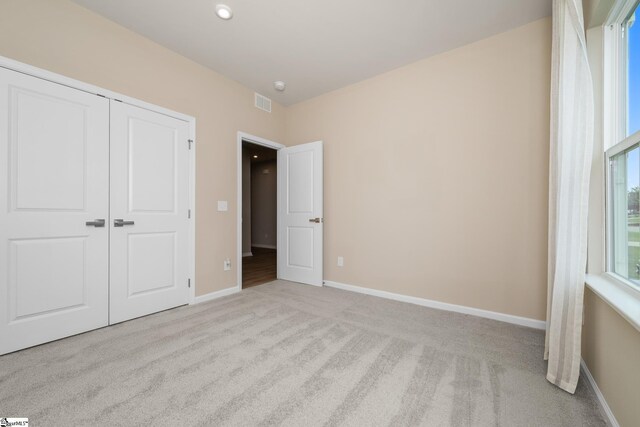 6010 Ives Ave, Spartanburg, SC 29307 - unfurnished bedroom featuring carpet flooring, baseboards, and a closet