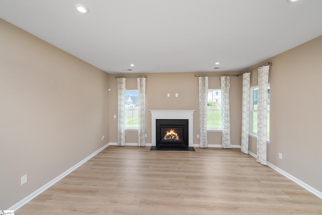 6010 Ives Ave, Spartanburg, SC 29307 - unfurnished living room with a fireplace with flush hearth, recessed lighting, baseboards, and light wood-type flooring