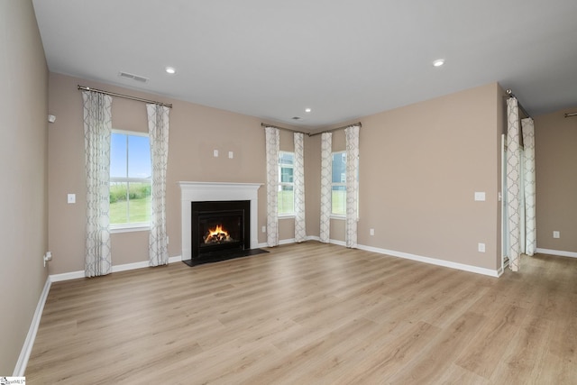 6010 Ives Ave, Spartanburg, SC 29307 - unfurnished living room with a fireplace with flush hearth, light wood-type flooring, baseboards, and recessed lighting