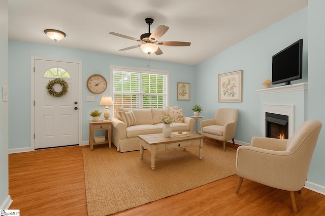 4 Yukon Dr, Greenville, SC 29605 - living room featuring light wood-type flooring, a ceiling fan, a lit fireplace, and baseboards