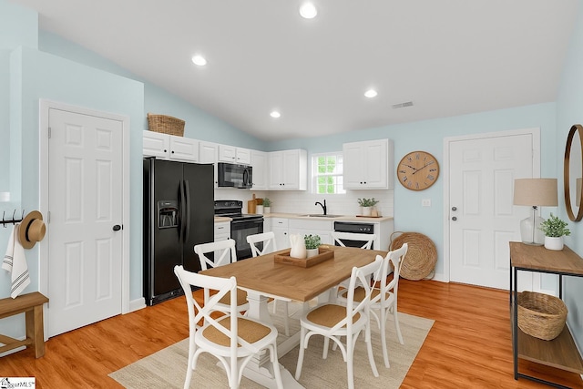 4 Yukon Dr, Greenville, SC 29605 - kitchen featuring black appliances, a sink, white cabinetry, light wood-style flooring, and lofted ceiling