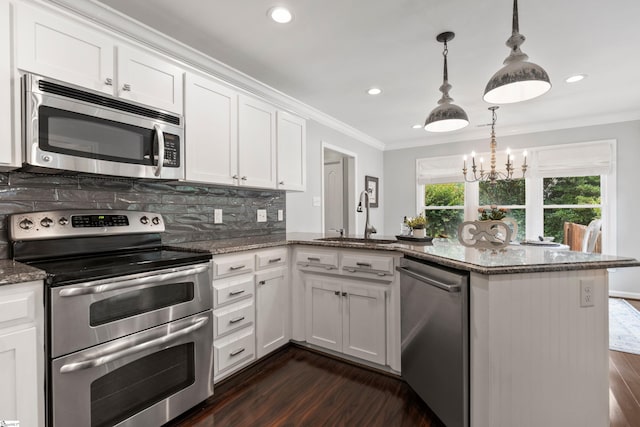 435 Grayson Dr, Moore, SC 29369 - kitchen with appliances with stainless steel finishes, a sink, dark wood-style flooring, a peninsula, and crown molding