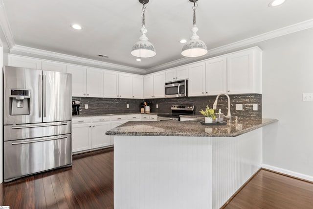 435 Grayson Dr, Moore, SC 29369 - kitchen featuring stainless steel appliances, dark stone countertops, ornamental molding, a peninsula, and white cabinets