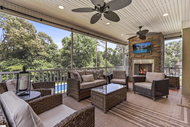 435 Grayson Dr, Moore, SC 29369 - sunroom / solarium with an outdoor living space with a fireplace, a ceiling fan, and view of wooded area
