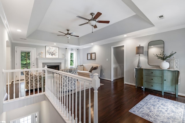 435 Grayson Dr, Moore, SC 29369 - living room featuring a tray ceiling, plenty of natural light, a ceiling fan, wood finished floors, and crown molding