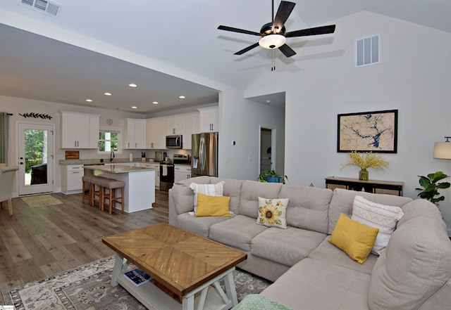 1608 Rock Springs Rd, Lavonia, GA 30553 - living area with vaulted ceiling, wood finished floors, recessed lighting, and ceiling fan