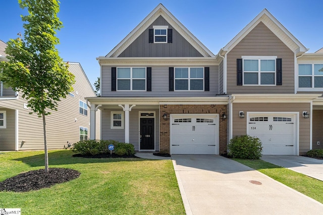 106 Cross Arbor Dr, Simpsonville, SC 29681 - view of front of house with board and batten siding, concrete driveway, a front yard, a garage, and brick siding