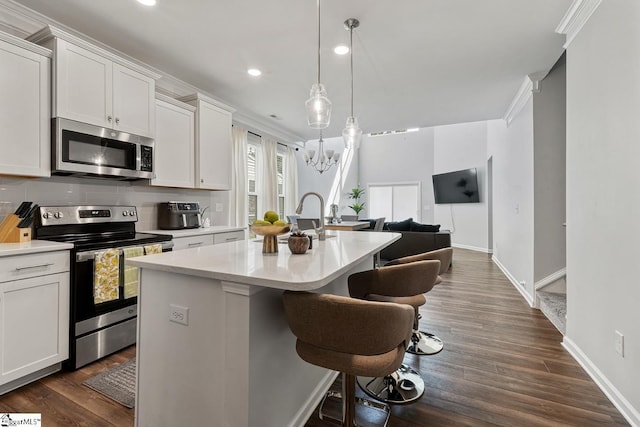 106 Cross Arbor Dr, Simpsonville, SC 29681 - kitchen featuring stainless steel appliances, light countertops, a chandelier, a kitchen island with sink, and dark wood-style flooring