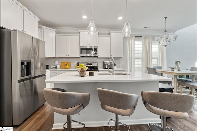 106 Cross Arbor Dr, Simpsonville, SC 29681 - kitchen with stainless steel appliances, a sink, light countertops, a kitchen breakfast bar, and decorative backsplash