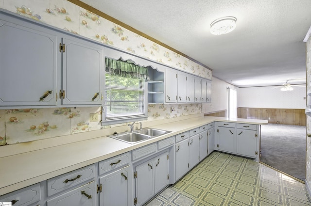 367 Janulis St, Spartanburg, SC 29301 - kitchen with wallpapered walls, a sink, light floors, a ceiling fan, and light countertops